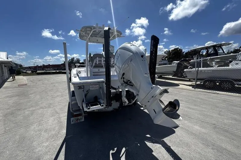 Slide: The Image of 2024 SPORTMAN MASTERS 227 boat with powerful outboard motor, parked under a sunny sky. - 6