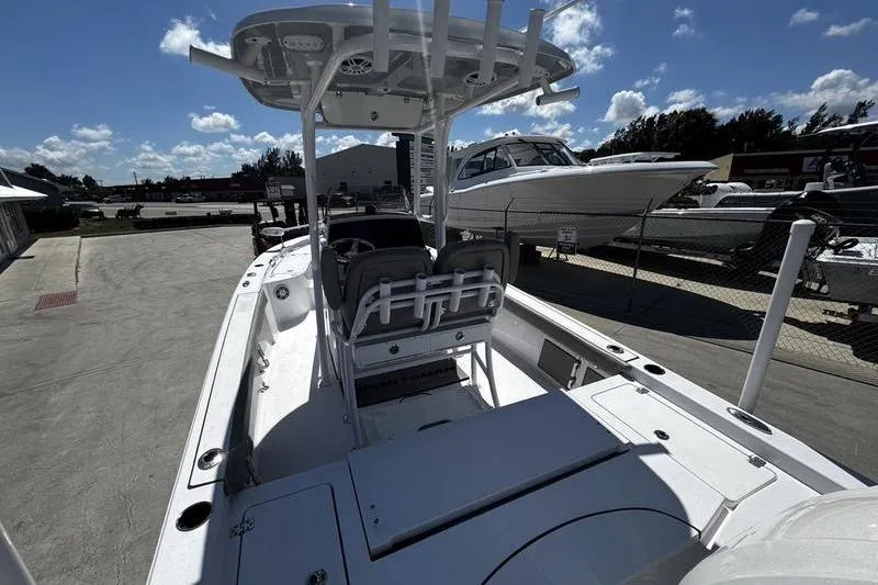 Slide: The Image of 2024 SPORTMAN MASTERS 227 boat, sleek design, docked under clear blue sky. - 7