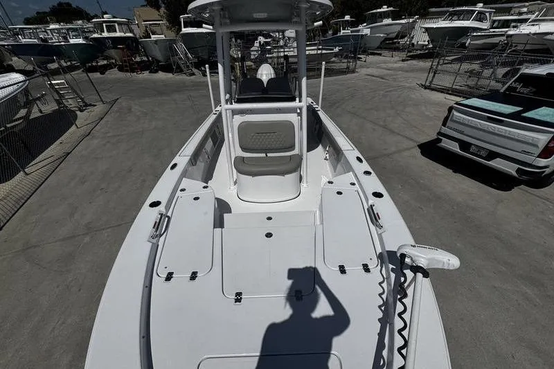 Slide: The Image of 2024 SPORTMAN MASTERS 227 boat on display at a marina, showcasing deck layout. - 9