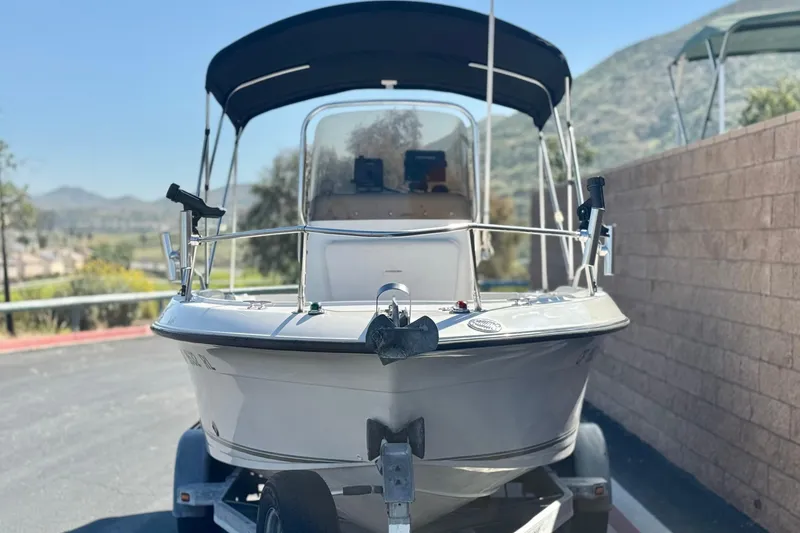 Slide: The Image of 2006 Seaswirl Striper 1851 Center Console boat on trailer, parked outdoors. - 2