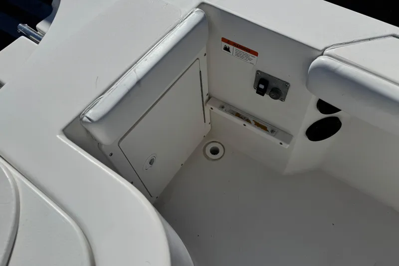 Slide: The Image of 2006 Seaswirl Striper 1851 Center Console O/B interior detail, featuring storage compartment and controls. - 20