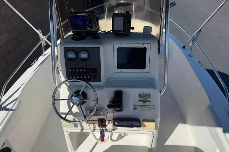 Slide: The Image of 2006 Seaswirl Striper 1851 Center Console O/B boat dashboard with steering wheel and navigation equipment. - 24