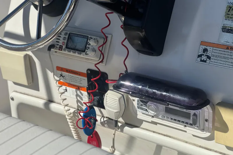 Slide: The Image of 2006 Seaswirl Striper 1851 Center Console dashboard with steering wheel and control panel. - 27