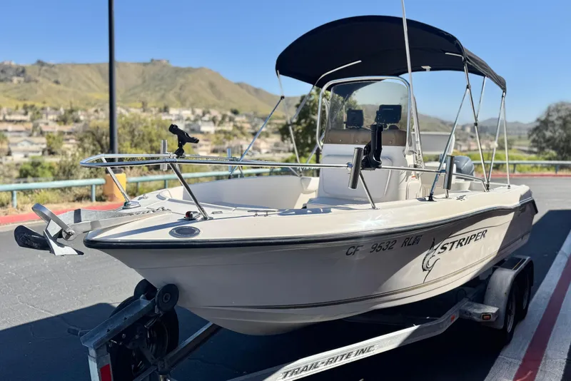 Slide: The Image of 2006 Seaswirl Striper 1851 Center Console boat on trailer, scenic background. - 3