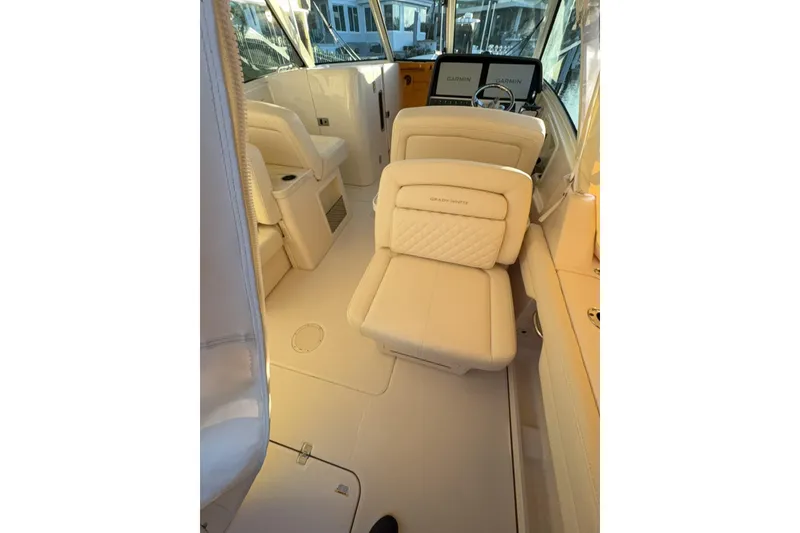 Slide: The Image of Interior of 2026 Grady-White Freedom 325 boat with luxurious seating and helm controls. - 10