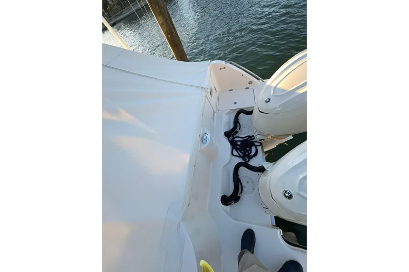 Slide: The Image of 2026 Grady-White Freedom 325 boat deck with twin engines and mooring ropes. - 16