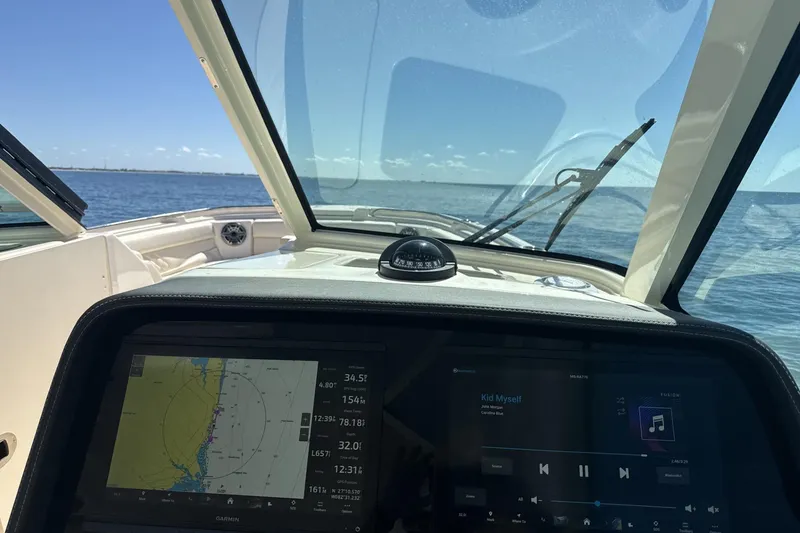 Slide: The Image of Cockpit view of 2026 Grady-White Freedom 325 boat with navigation display. - 4
