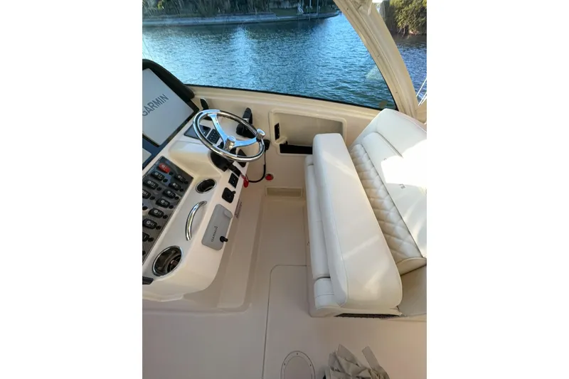 Slide: The Image of Helm of 2026 Grady-White Freedom 325 boat with steering wheel and controls. - 9