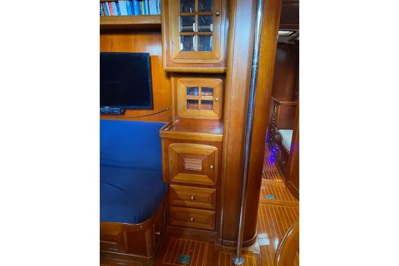 Slide: The Image of Interior of 1990 Little Harbor Sloop, featuring wooden cabinetry and seating area. - 11