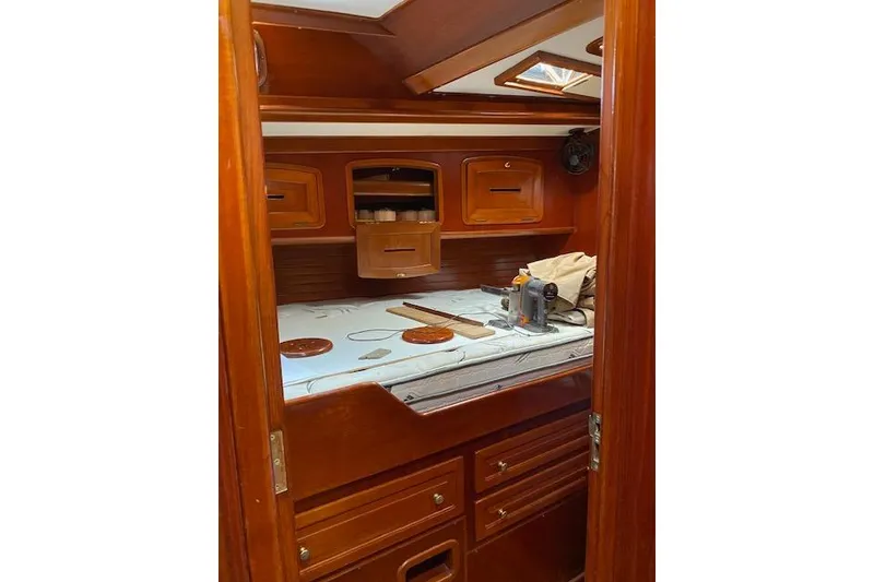 Slide: The Image of Cozy cabin interior of 1990 Little Harbor Sloop 58', featuring wooden cabinetry and bedding. - 14