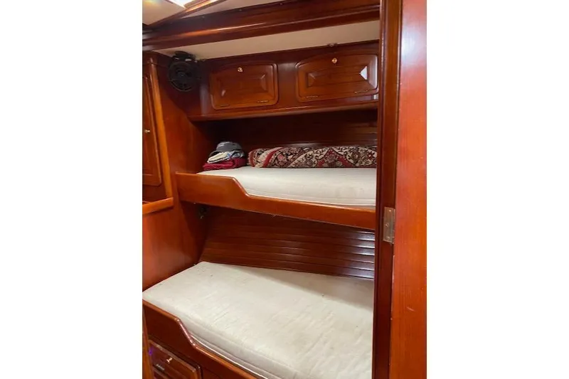 Slide: The Image of Interior of 1990 Little Harbor Sloop 58' with wooden bunk beds and storage cabinets. - 15