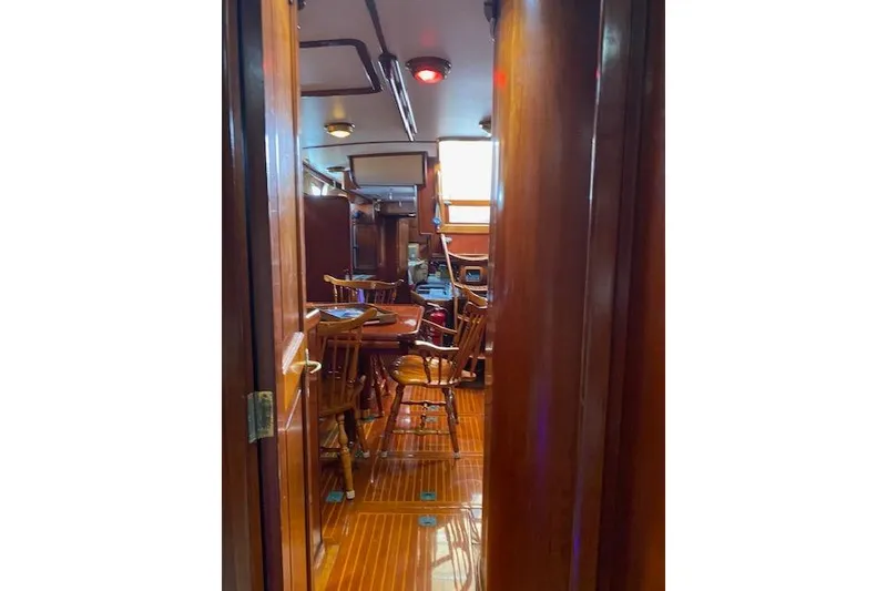 Slide: The Image of Interior view of 1990 Little Harbor Sloop 58' with wooden furnishings and cozy seating area. - 18