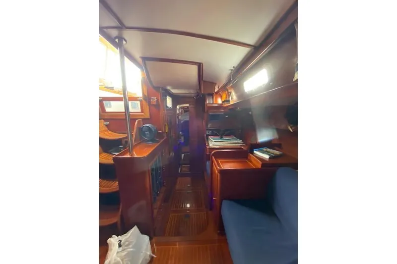 Slide: The Image of Interior of 1990 Little Harbor Sloop 58', featuring polished wood and cozy seating. - 23