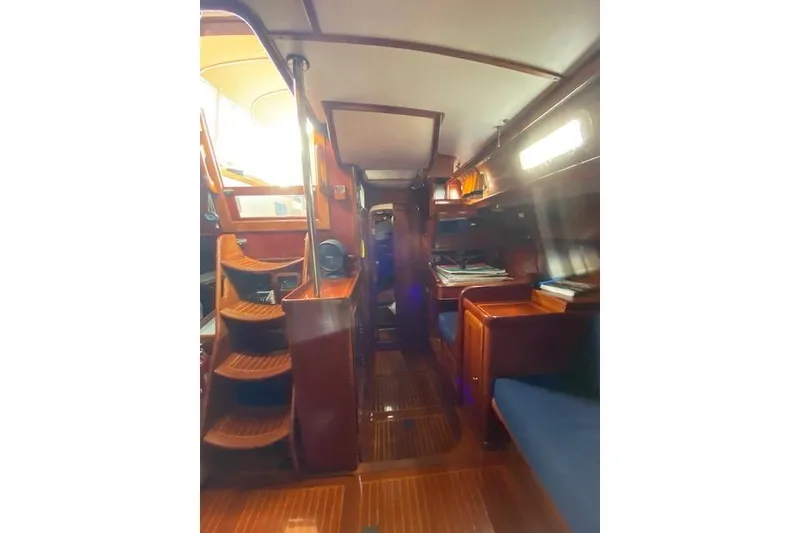 Slide: The Image of Interior of 1990 Little Harbor Sloop 58', featuring wooden finishes and cozy seating. - 24