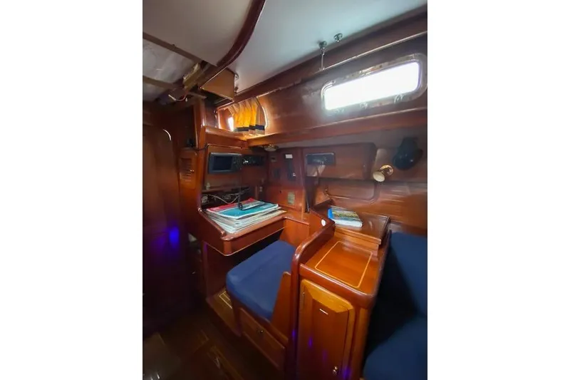 Slide: The Image of Interior of 1990 Little Harbor Sloop 58' with wooden cabinetry and navigation station. - 25