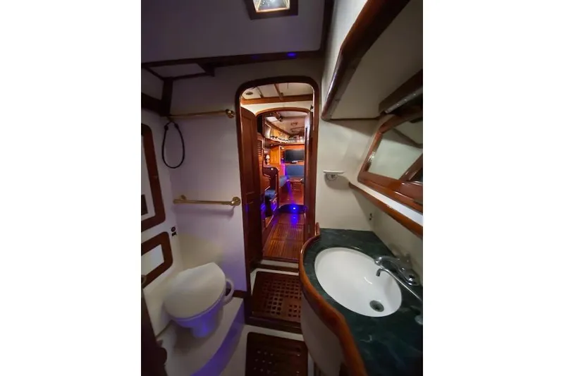 Slide: The Image of Interior of 1990 Little Harbor Sloop 58' yacht, featuring bathroom and cabin view. - 27