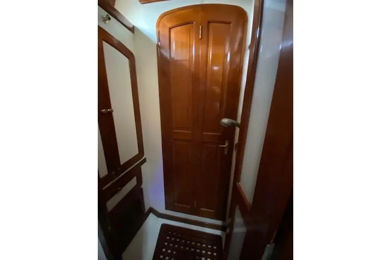 Slide: The Image of Interior of 1990 Little Harbor Sloop 58' with polished wooden doors and trim. - 28