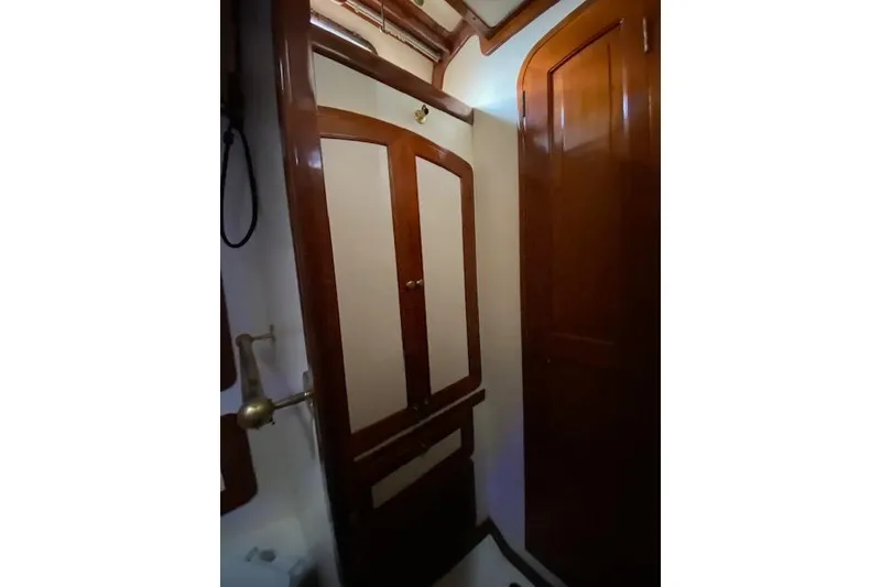 Slide: The Image of Interior of 1990 Little Harbor Sloop 58' with wooden cabinetry and brass fixtures. - 29