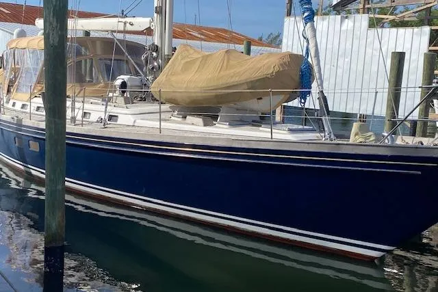 Slide: The Image of 1990 Little Harbor Sloop 58' with blue hull docked at marina. - 3