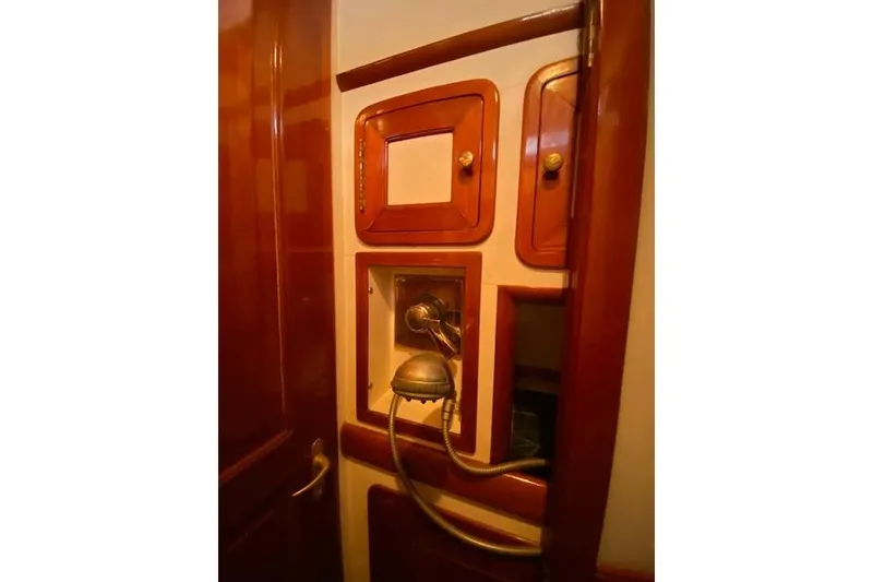 Slide: The Image of Interior of 1990 Little Harbor Sloop, featuring wooden cabinetry and vintage shower fixtures. - 30