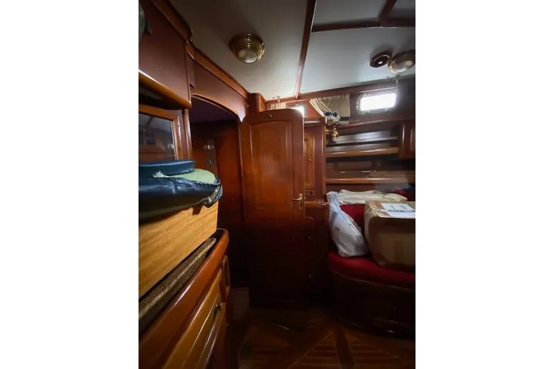 Slide: The Image of Interior of 1990 Little Harbor Sloop 58' with wooden cabinetry and cozy seating area. - 31