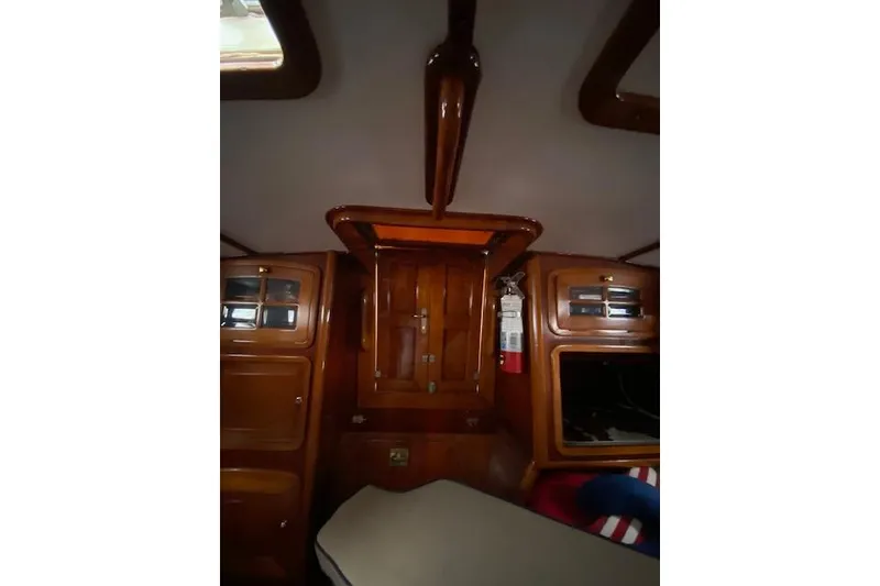 Slide: The Image of Interior of 1990 Little Harbor Sloop 58' with wooden cabinetry and fire extinguisher. - 32
