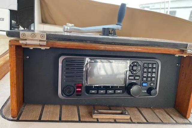 Slide: The Image of 1990 Little Harbor Sloop 58' radio equipment with wooden paneling and control handle. - 5