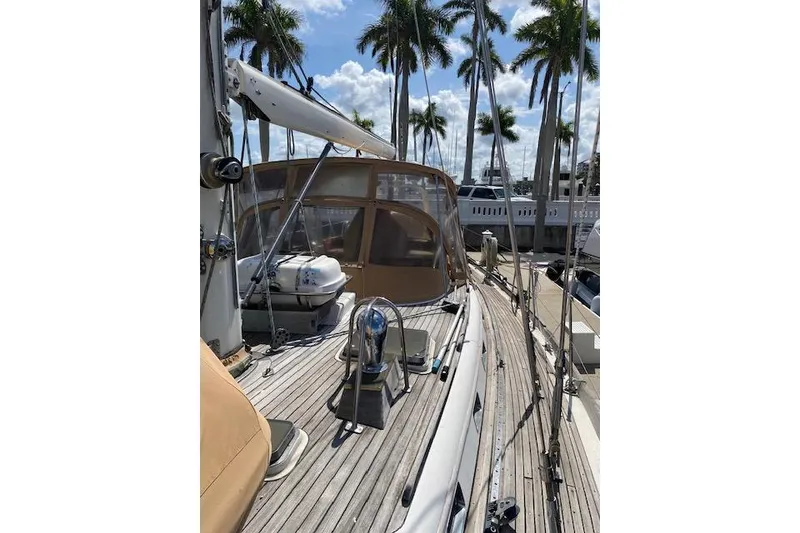 Slide: The Image of 1990 Little Harbor Sloop 58' yacht docked, featuring teak deck and palm trees in background. - 50