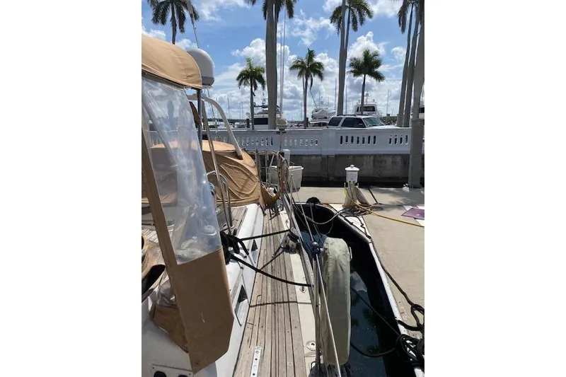Slide: The Image of 1990 Little Harbor Sloop 58' docked, with palm trees and clear sky in the background. - 55