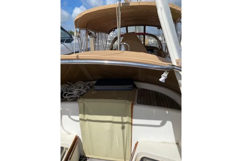 Slide: The Image of 1990 Little Harbor Sloop 58' cockpit with tan canopy and ropes. - 56