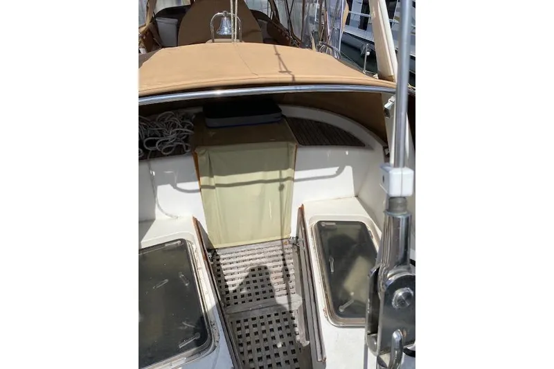 Slide: The Image of 1990 Little Harbor Sloop 58' cockpit with tan cover and visible rope storage. - 57