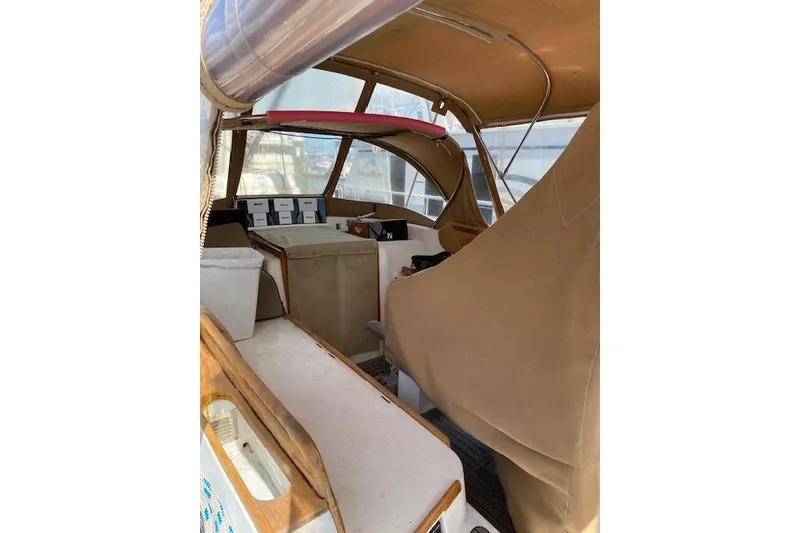 Slide: The Image of 1990 Little Harbor Sloop 58' interior with tan covers and seating area. - 58