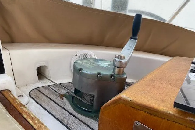 Slide: The Image of Cockpit winch on 1990 Little Harbor Sloop 58', featuring teak accents and marine equipment. - 6