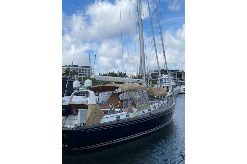Slide: The Image of 1990 Little Harbor Sloop 58' yacht docked in marina under blue sky. - 64