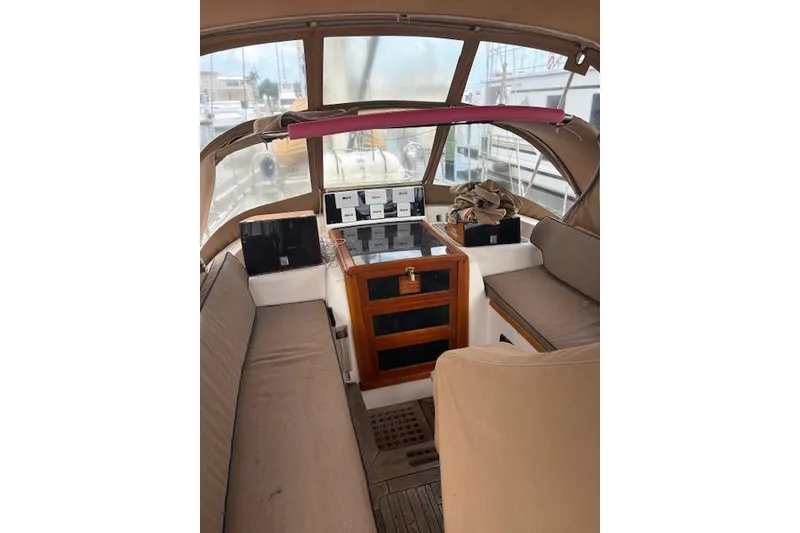 Slide: The Image of Interior view of a 1990 Little Harbor Sloop 58' sailboat cockpit with seating and navigation equipment. - 65