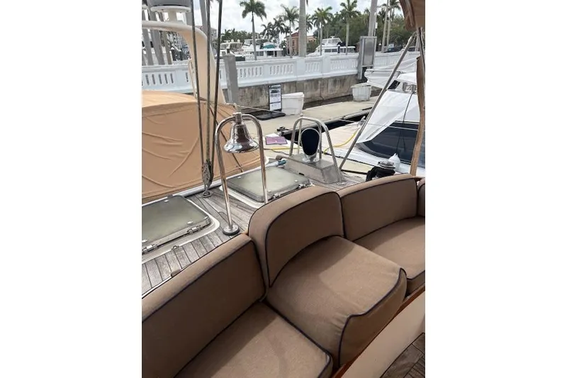 Slide: The Image of 1990 Little Harbor Sloop 58' yacht interior with cushioned seating and deck view. - 67