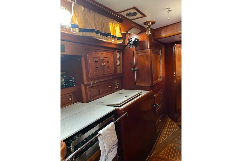 Slide: The Image of Interior of 1990 Little Harbor Sloop 58' with wooden cabinetry and nautical decor. - 7