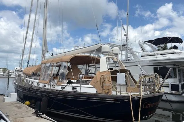 Slide: The Image of 1990 Little Harbor Sloop 58' docked at marina under cloudy sky. - 74
