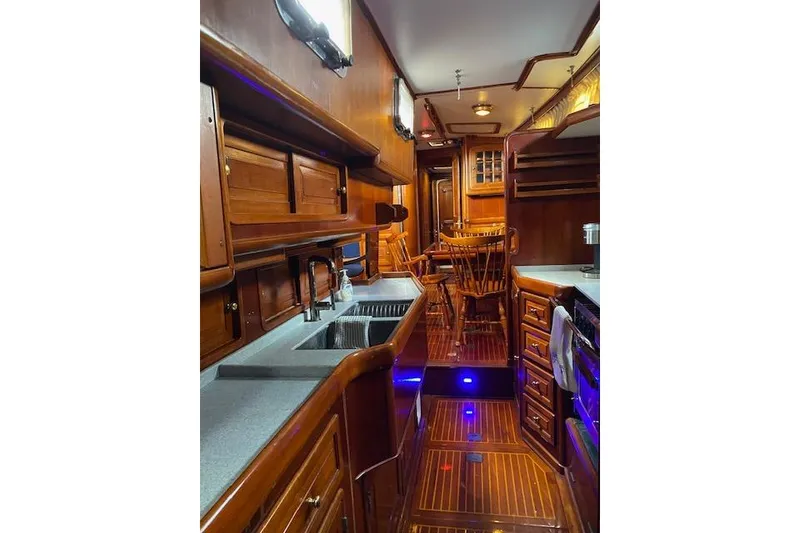 Slide: The Image of Luxurious wooden interior of 1990 Little Harbor Sloop 58' yacht, featuring a galley and dining area. - 8