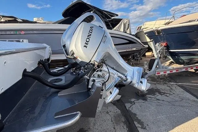 Slide: The Image of 2023 North River 23' Seahawk with Honda outboard motor in a marina setting. - 5