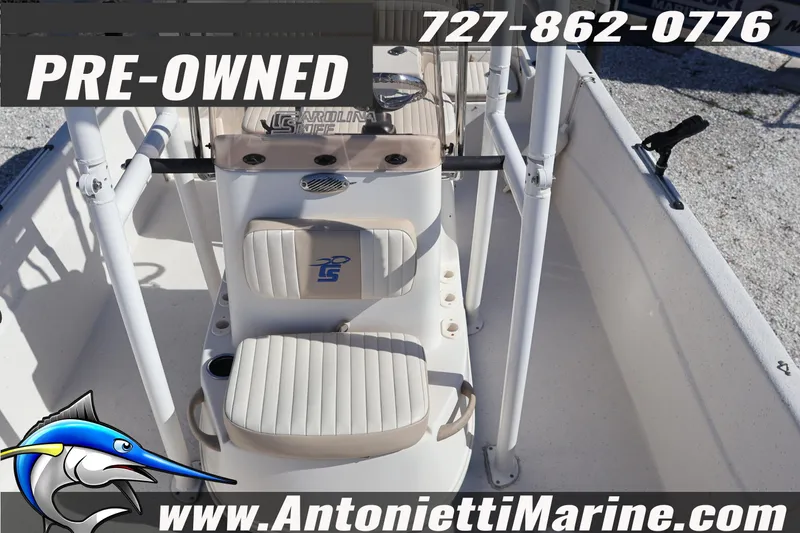 Slide: The Image of Pre-owned 2016 Carolina Skiff 178 DLV boat interior with seating and console. - 15