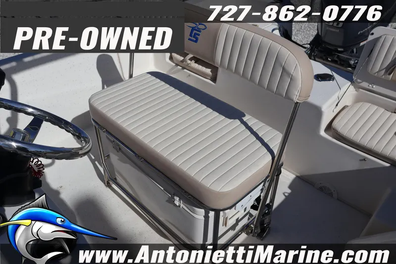 Slide: The Image of Pre-owned 2016 Carolina Skiff 178 DLV boat interior with seating and steering wheel. - 21