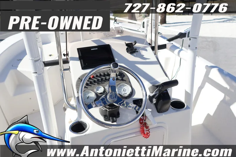 Slide: The Image of Pre-owned 2016 Carolina Skiff 178 DLV boat dashboard with steering wheel and controls. - 24