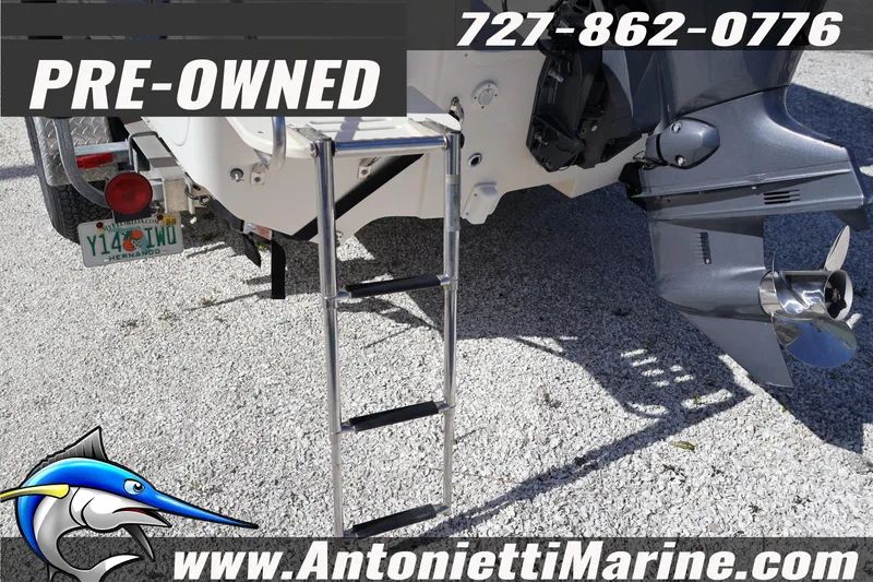 Slide: The Image of Pre-owned 2016 Carolina Skiff 178 DLV boat with ladder and outboard motor. - 8
