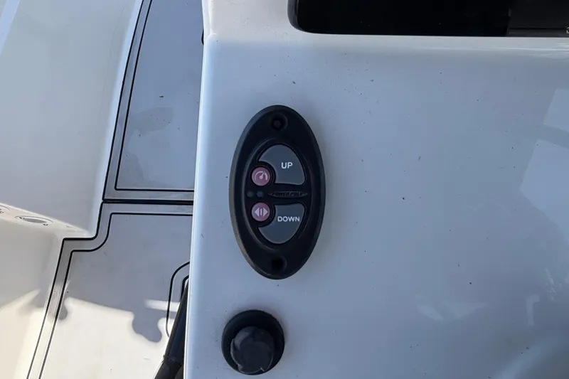 Slide: The Image of Control panel on 2023 Sea Born LX24 Center Console boat, featuring up and down buttons. - 12