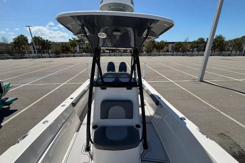 Slide: The Image of 2023 Sea Born LX24 Center Console boat in a parking lot, showcasing seating and console. - 14