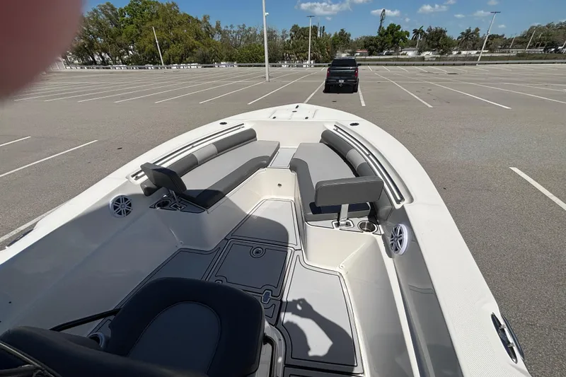 Slide: The Image of 2023 Sea Born LX24 Center Console boat in a parking lot, showcasing seating and deck layout. - 18