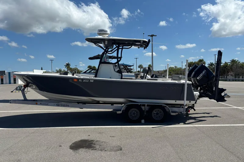 Slide: The Image of 2023 Sea Born LX24 Center Console boat on trailer in sunny parking lot. - 3