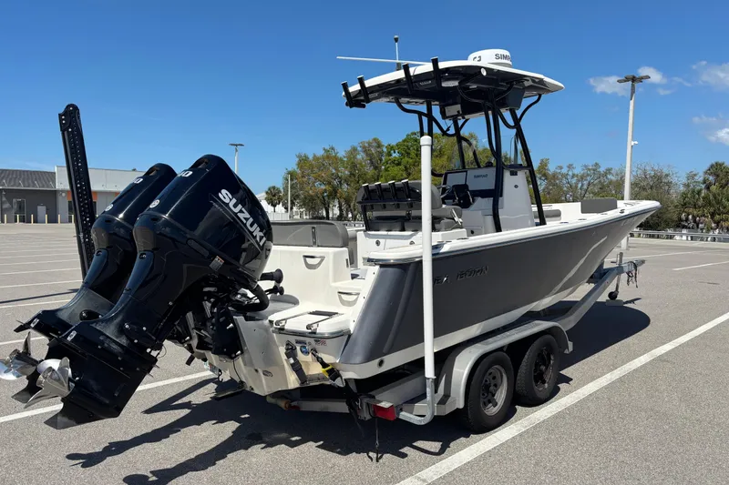 Slide: The Image of 2023 Sea Born LX24 Center Console boat on trailer with dual Suzuki engines. - 6