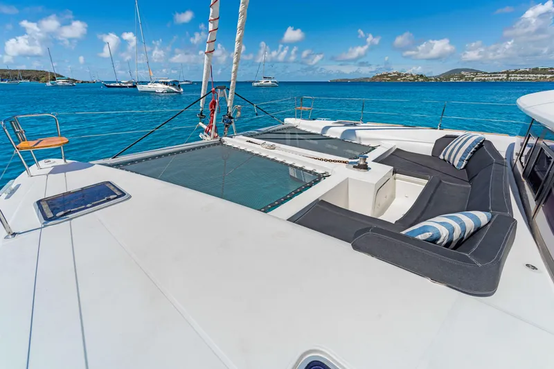Slide: The Image of Luxurious 2017 Lagoon 450 F catamaran deck with seating, overlooking serene blue waters. - 10